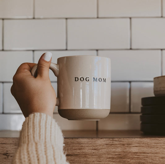 DOG MOM mug held by hand
