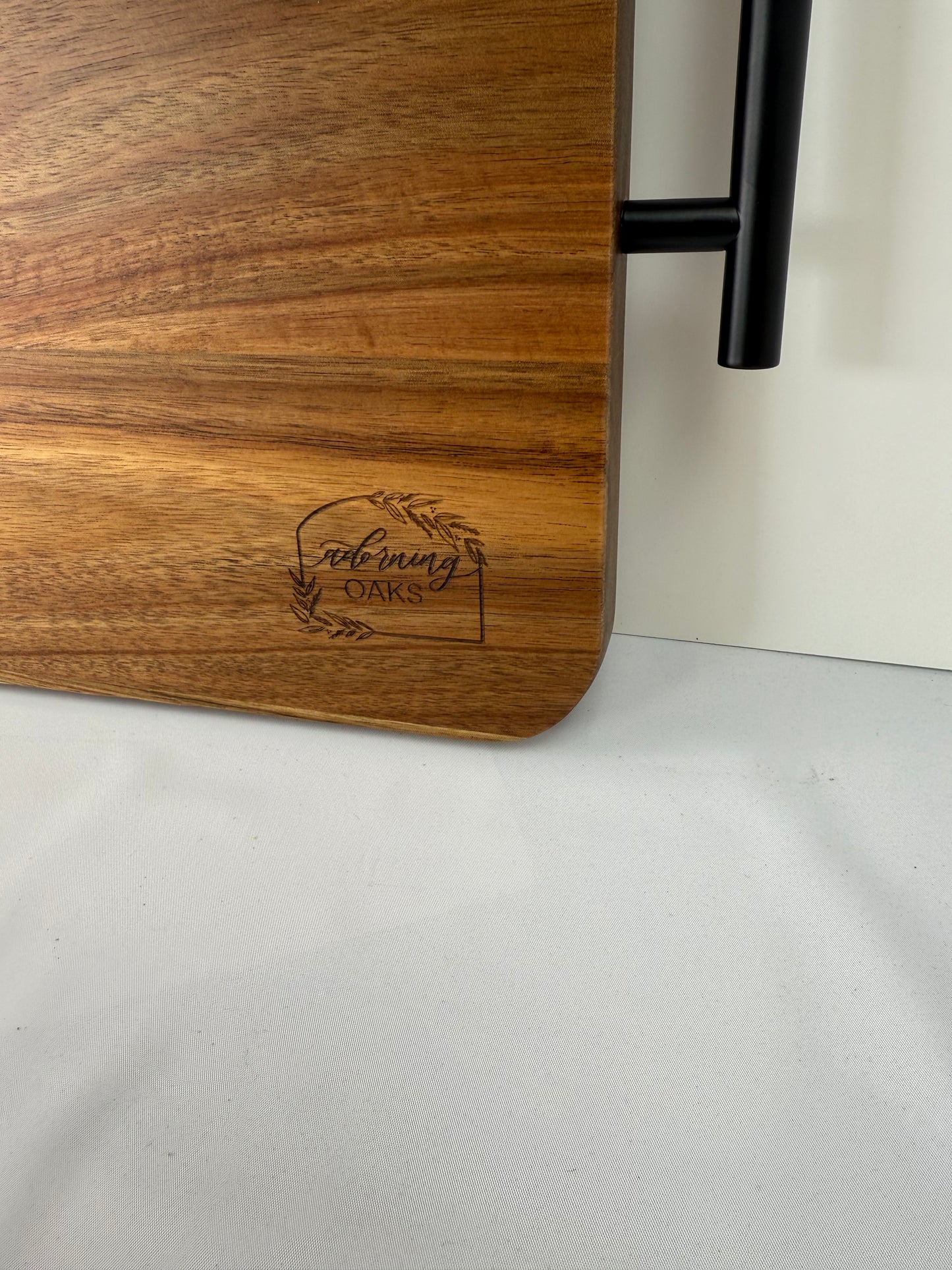 Wooden cutting board with engraved text on a white surface