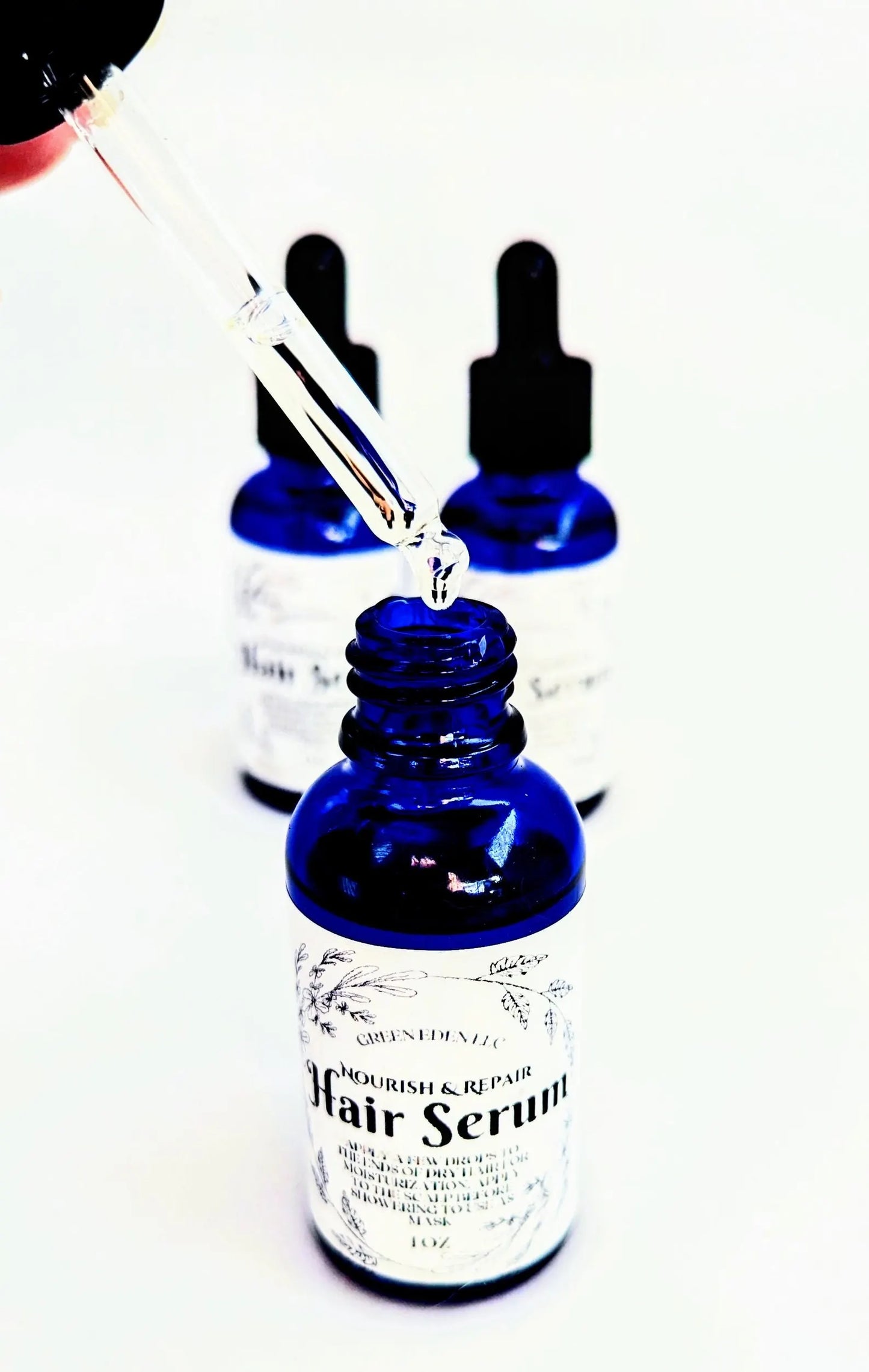 open lid on nourish and repair hair serum with white background