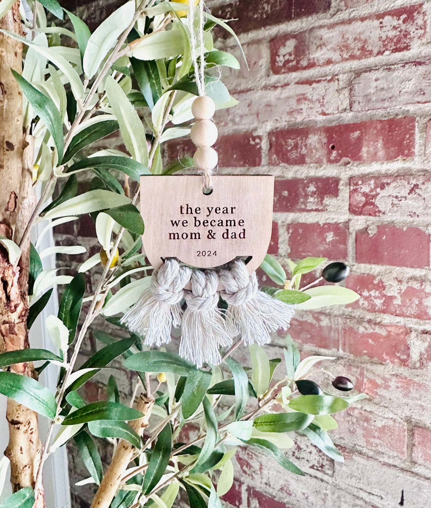 the year we became mom & dad ornament hanging on tree