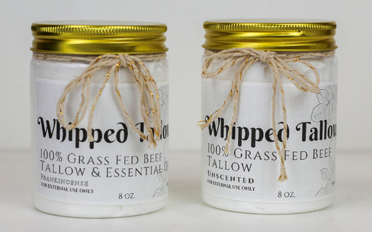 Two glass jars of Green Eden Whipped Tallow, one with a label and the other without. Both jars have a rope-like twine on the lid for a total of four jars.