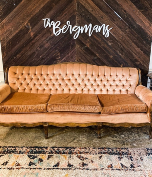 Large wooden name sign hung up on wall.