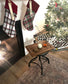 Christmas stockings hanging by a fireplace with a decorated tree in the background.
