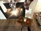 Tray with a glass of water, cookie, and carrot in front of a fireplace with stockings hanging above.